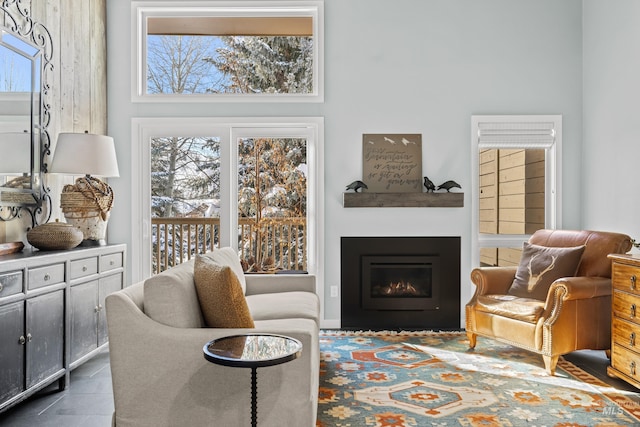 2226 Bonne Vie Condo Dr, Sun Valley, ID 83353 - living room featuring healthy amount of natural light, a lit fireplace, and a towering ceiling