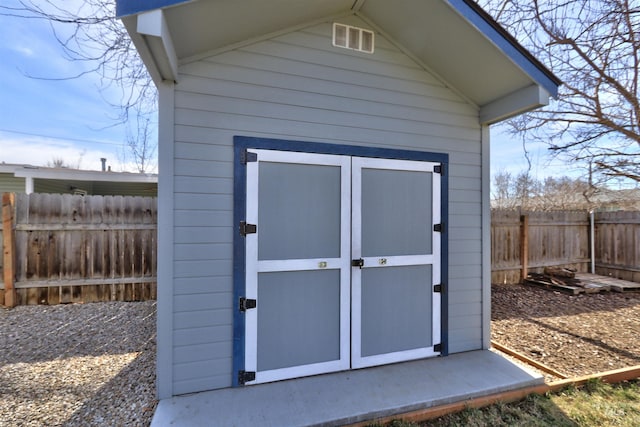 view of shed with a fenced backyard