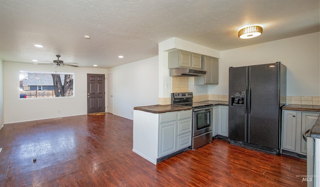 kitchen featuring dark countertops, under cabinet range hood, dark wood finished floors, stainless steel electric range, and black refrigerator with ice dispenser