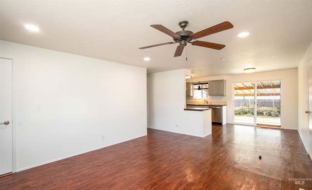 unfurnished living room with recessed lighting, baseboards, dark wood-type flooring, and ceiling fan