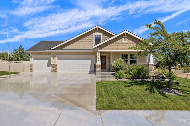 craftsman house featuring a front yard and a garage