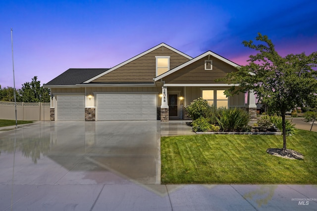 craftsman house with a lawn and a garage