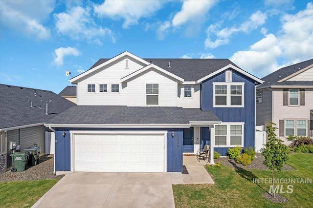 1266 S Wiston Ave, Kuna, ID 83634 - view of front of property featuring driveway, a garage, board and batten siding, and a front lawn