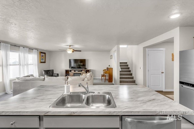 1266 S Wiston Ave, Kuna, ID 83634 - kitchen with a sink, appliances with stainless steel finishes, open floor plan, ceiling fan, and light countertops