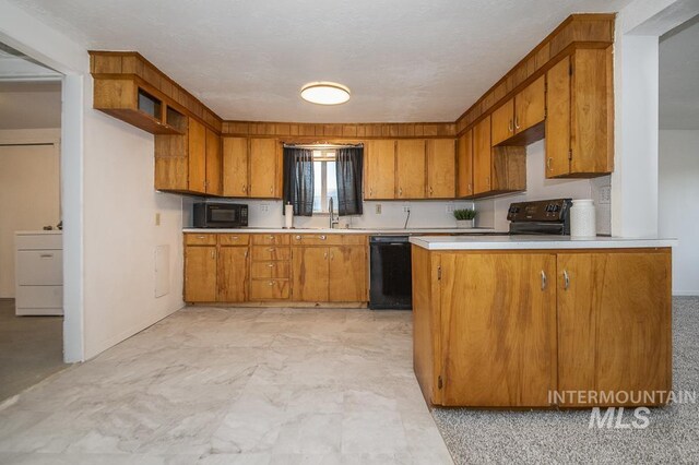 602 Nevada Ave, Homedale, ID 83628 - kitchen with black appliances, brown cabinetry, light countertops, and a peninsula