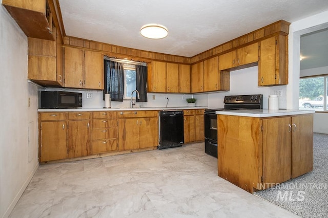 602 Nevada Ave, Homedale, ID 83628 - kitchen featuring black appliances, brown cabinets, light countertops, and light marble finish flooring