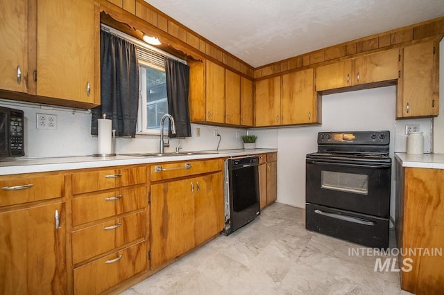 602 Nevada Ave, Homedale, ID 83628 - kitchen with black appliances, light countertops, and brown cabinets