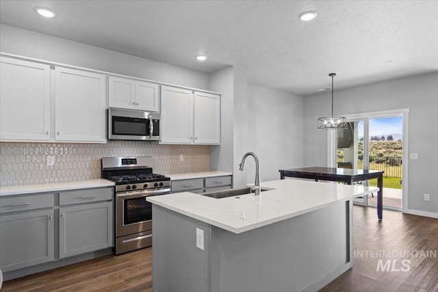 8450 S Bogus Ridge Ave, Boise, ID 83716 - kitchen with appliances with stainless steel finishes, a sink, decorative backsplash, gray cabinetry, and recessed lighting