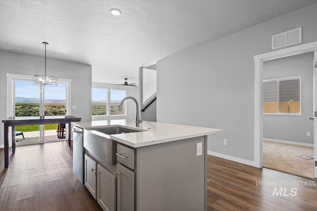 8450 S Bogus Ridge Ave, Boise, ID 83716 - kitchen with a sink, stainless steel dishwasher, ceiling fan, gray cabinets, and a textured ceiling