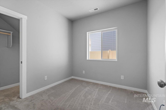 8450 S Bogus Ridge Ave, Boise, ID 83716 - unfurnished bedroom featuring carpet floors, baseboards, and a walk in closet