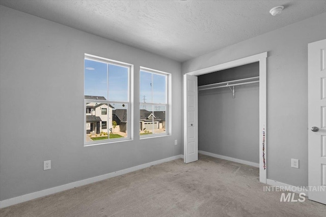 8450 S Bogus Ridge Ave, Boise, ID 83716 - unfurnished bedroom with carpet flooring, a textured ceiling, baseboards, and a closet
