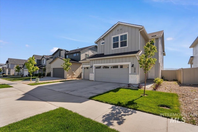 8450 S Bogus Ridge Ave, Boise, ID 83716 - view of front of property with board and batten siding, a residential view, concrete driveway, and an attached garage
