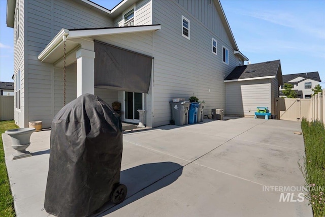 8450 S Bogus Ridge Ave, Boise, ID 83716 - rear view of property with a patio area, a gate, board and batten siding, and concrete driveway
