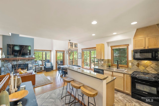 23 Golden Bar Ct, Donnelly, ID 83615 - kitchen featuring black appliances, light brown cabinets, a center island, and recessed lighting