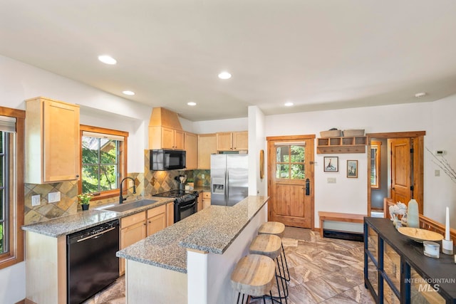 23 Golden Bar Ct, Donnelly, ID 83615 - kitchen featuring black appliances, light brown cabinetry, plenty of natural light, a center island, and recessed lighting