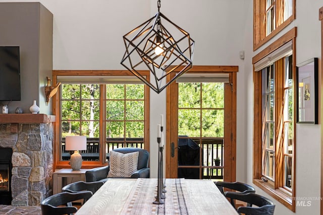 23 Golden Bar Ct, Donnelly, ID 83615 - dining room featuring a stone fireplace and a towering ceiling