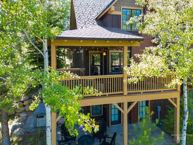 23 Golden Bar Ct, Donnelly, ID 83615 - rear view of house featuring board and batten siding, a shingled roof, and a wooden deck