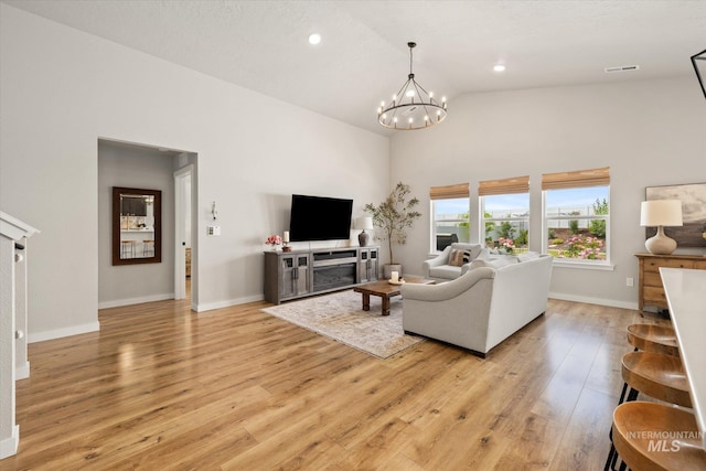2188 Navigator St, Middleton, ID 83644 - living area featuring high vaulted ceiling, light wood-style floors, a chandelier, and recessed lighting