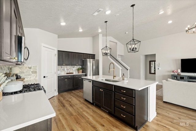 2188 Navigator St, Middleton, ID 83644 - kitchen with appliances with stainless steel finishes, a chandelier, open floor plan, vaulted ceiling, and tasteful backsplash