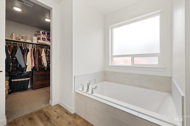 2188 Navigator St, Middleton, ID 83644 - full bath featuring a garden tub, wood finished floors, and a walk in closet