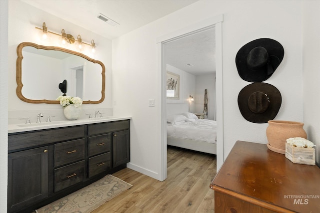 2188 Navigator St, Middleton, ID 83644 - full bathroom with wood finished floors, double vanity, and connected bathroom