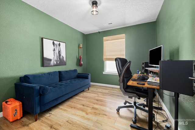 2188 Navigator St, Middleton, ID 83644 - office with light wood-type flooring, a textured ceiling, and a textured wall