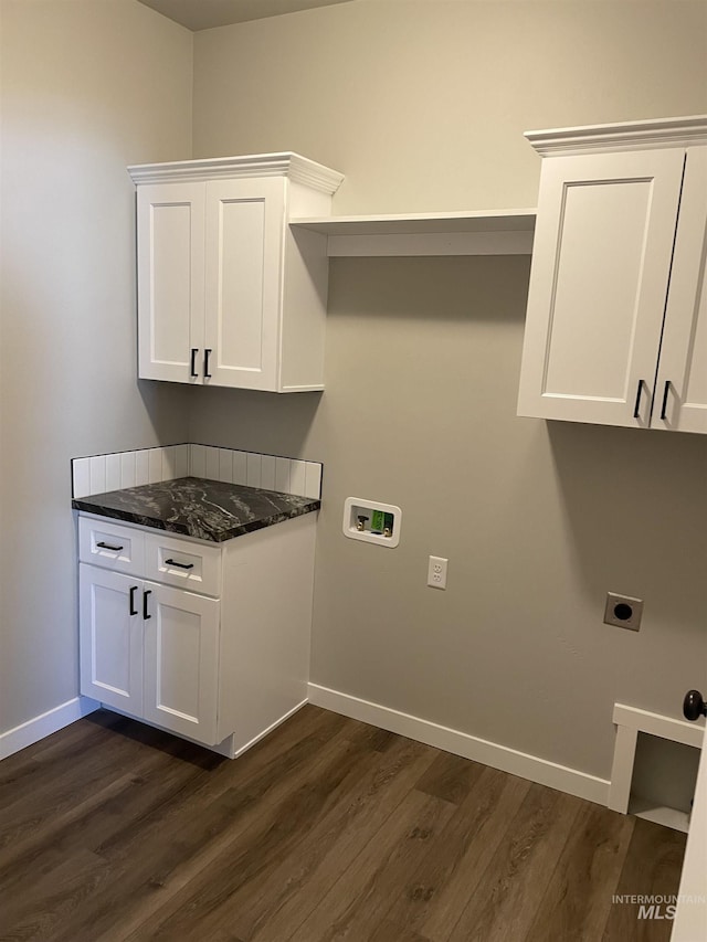 laundry room with dark wood-style floors, cabinet space, hookup for an electric dryer, and baseboards