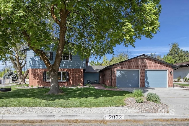 view of front of property with a front lawn, brick siding, driveway, and a garage