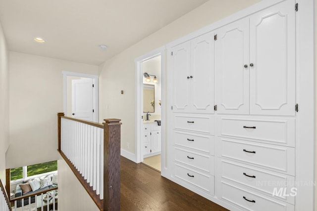 hallway featuring baseboards, an upstairs landing, recessed lighting, and dark wood-style floors