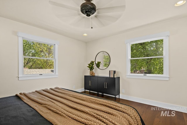 bedroom featuring recessed lighting, wood finished floors, and multiple windows