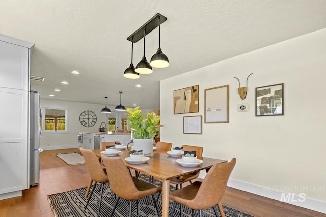 dining area with baseboards, recessed lighting, and wood finished floors