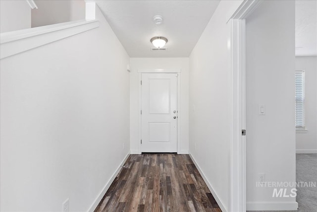 hall with dark hardwood / wood-style flooring