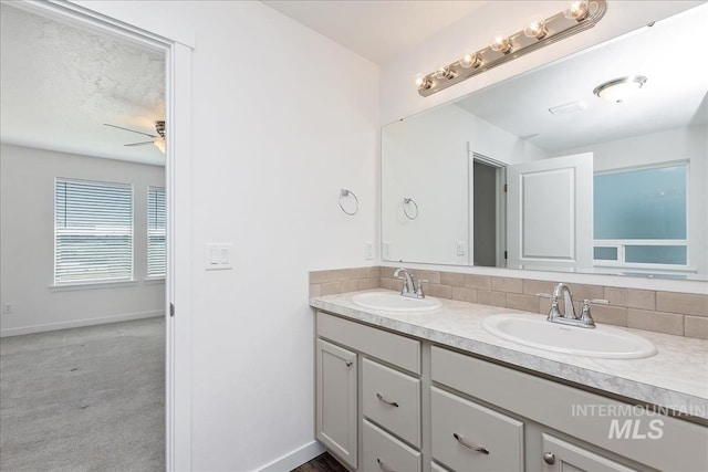 bathroom featuring decorative backsplash, vanity, and ceiling fan