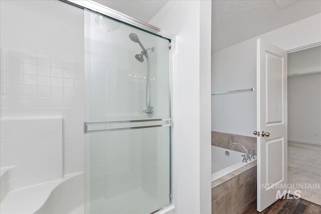 bathroom with hardwood / wood-style flooring and separate shower and tub