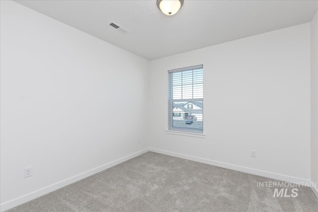 empty room featuring light carpet