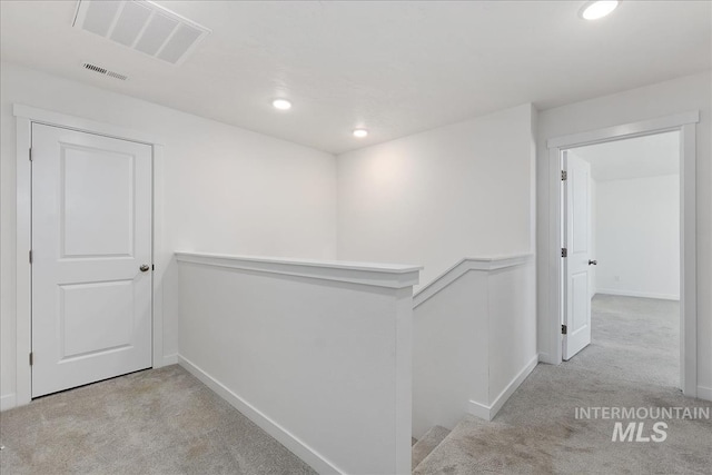 hallway featuring light carpet