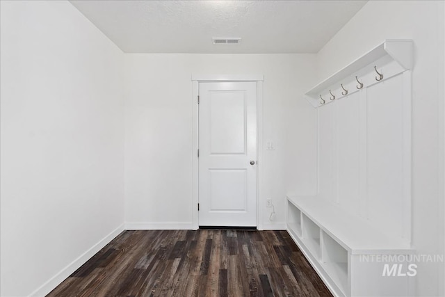 mudroom with dark hardwood / wood-style flooring and a textured ceiling