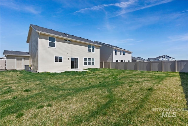 rear view of property featuring a yard and central AC