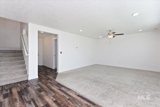 spare room featuring a textured ceiling, ceiling fan, and dark hardwood / wood-style floors