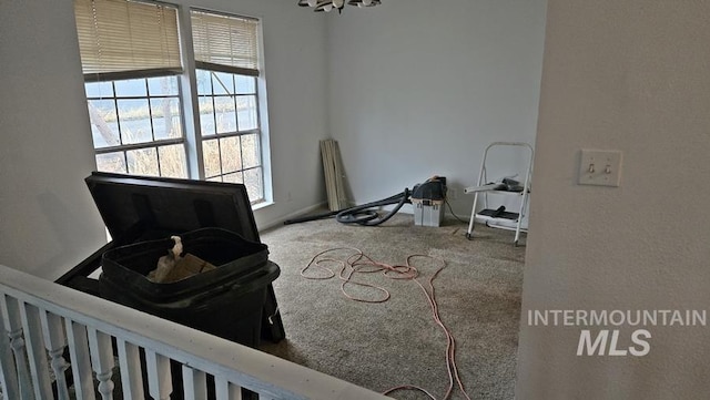 interior space with carpet flooring, a chandelier, and plenty of natural light