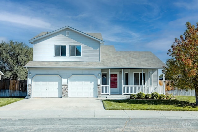 view of front of home with a porch, a garage, and a front yard