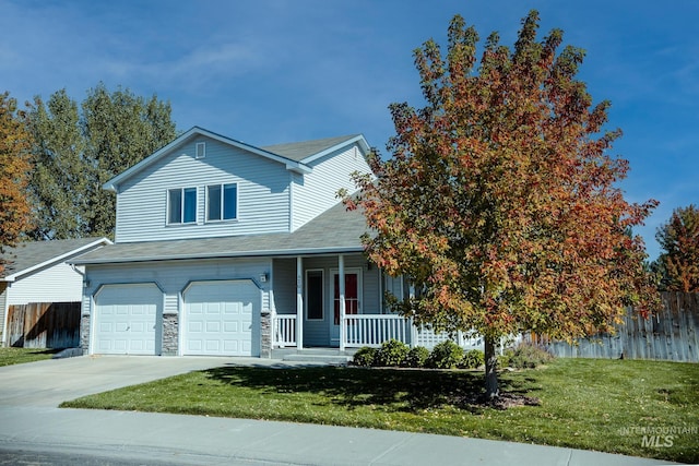 view of front of house featuring a garage, a front lawn, and a porch