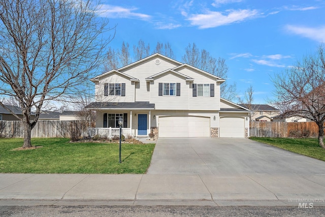 traditional home featuring fence, a porch, a front yard, stone siding, and driveway