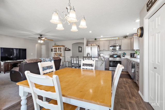 dining space featuring recessed lighting, ceiling fan with notable chandelier, arched walkways, and a textured ceiling