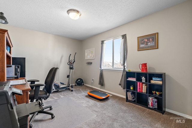 carpeted office space featuring a textured ceiling and baseboards