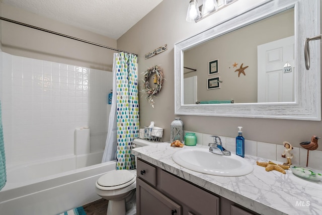 bathroom with vanity, toilet, shower / bath combo, and a textured ceiling