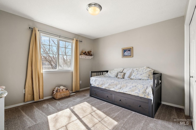 carpeted bedroom featuring baseboards