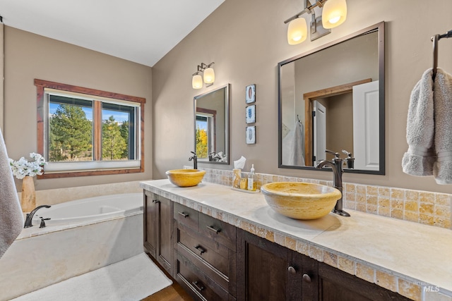 306 Otter Pond Ln, Mccall, ID 83638 - bathroom featuring double vanity, a sink, and a garden tub