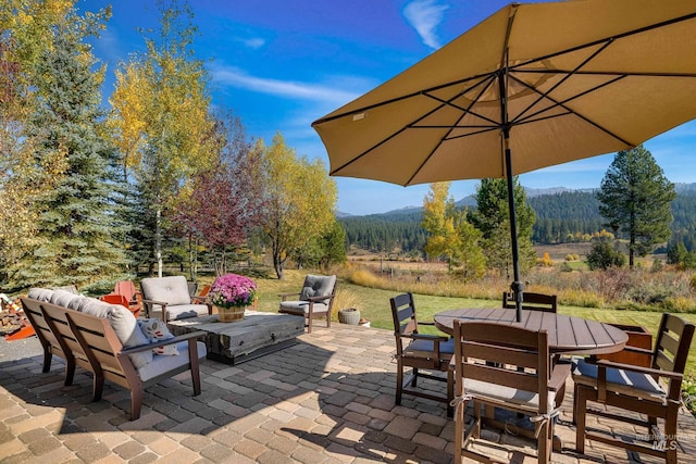 306 Otter Pond Ln, Mccall, ID 83638 - view of patio with a view of trees, outdoor lounge area, a mountain view, and outdoor dining space