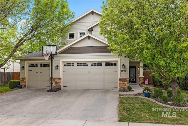 view of front facade featuring driveway, stone siding, fence, and a garage